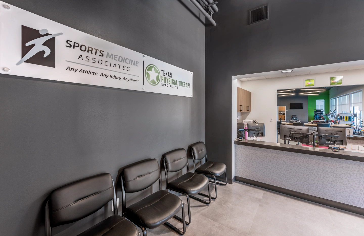 Sports Medicine Associates and Texas Physical Therapy Specialists waiting room and reception desk overlooking the physical therapy gym.