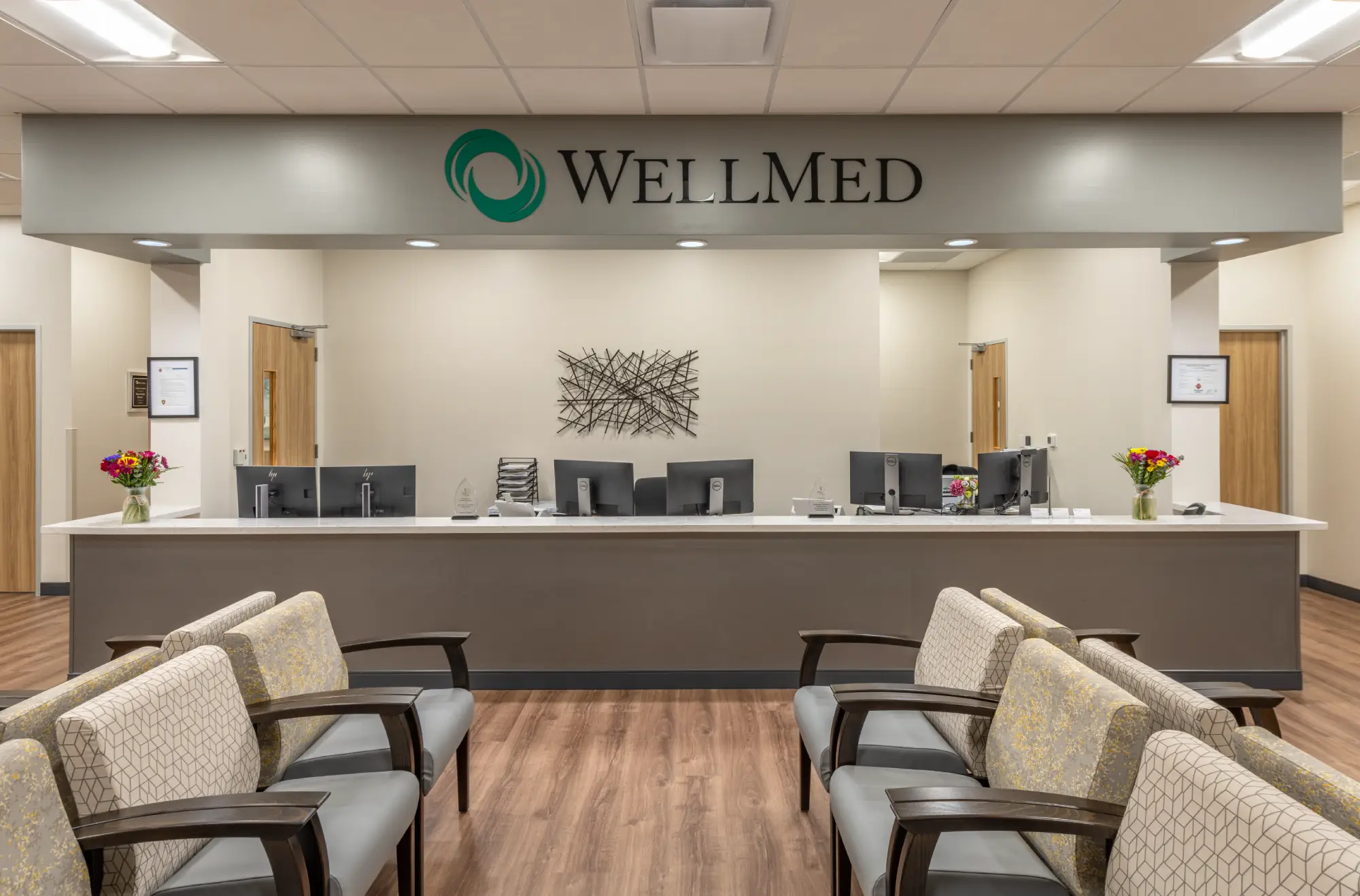WellMed reception desk with waiting room seating and sculptural wall art