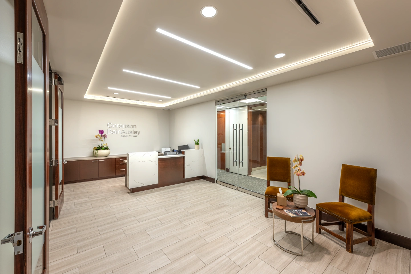 Goranson Bain Ausley family law reception and waiting area with marble desk, velvet chairs, and branded signage.